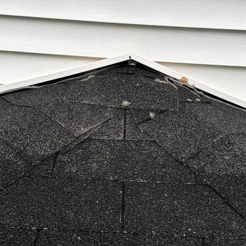 Roof shingles with hail damage and missing granules