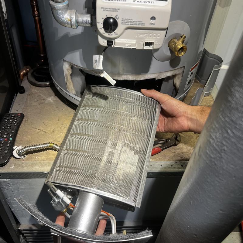 Water heater pilot assembly replacement in progress