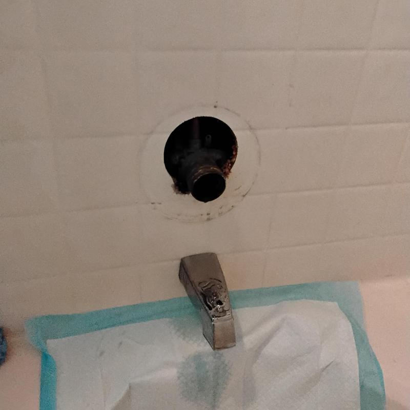 Bathtub faucet plumbing exposed with copper supply pipe