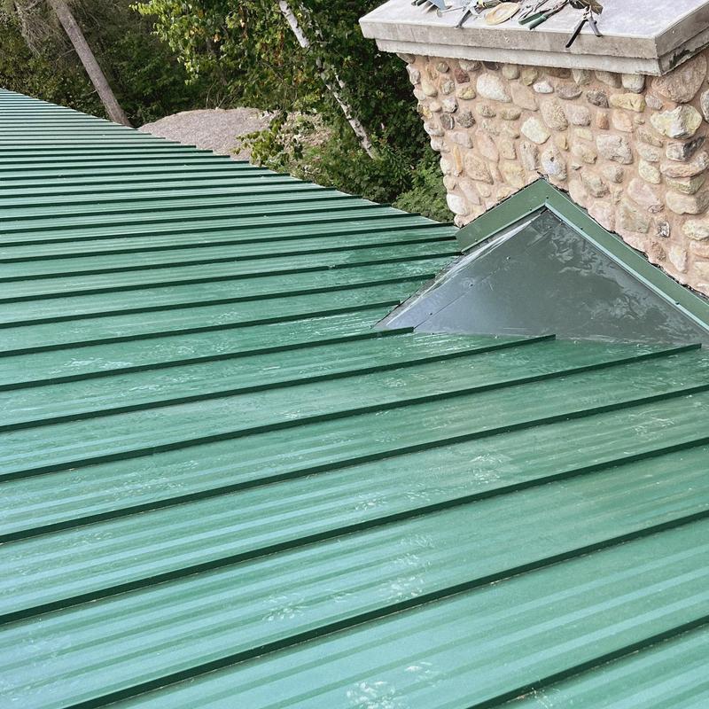 Standing seam metal roof flashing at chimney soldered and sealed Standing seam metal roof flashing at chimney soldered and sealed