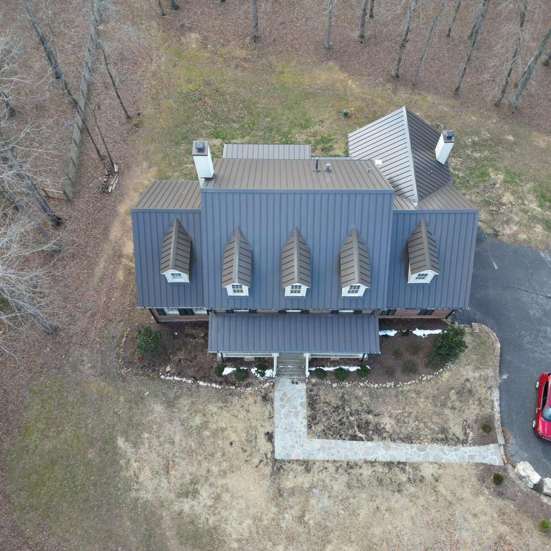 Metal roof inspection with dormers and chimneys