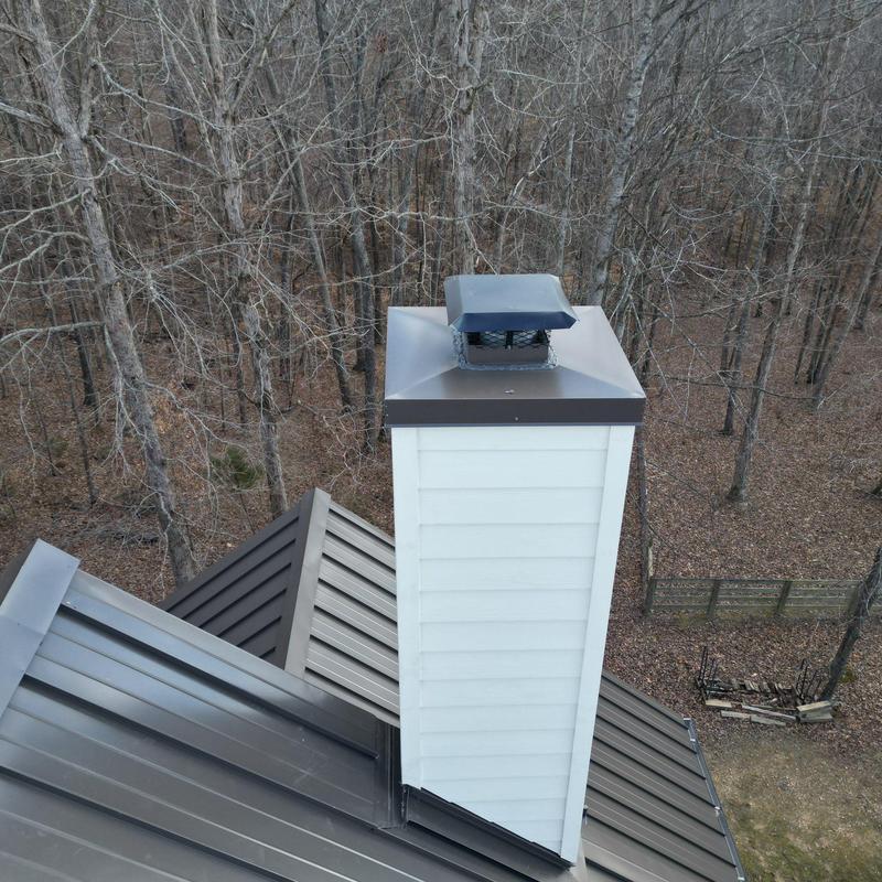Metal roof and chimney cap inspection on home roof