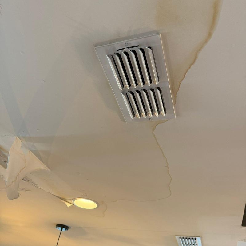 Ceiling air vent with water damage and peeling paint