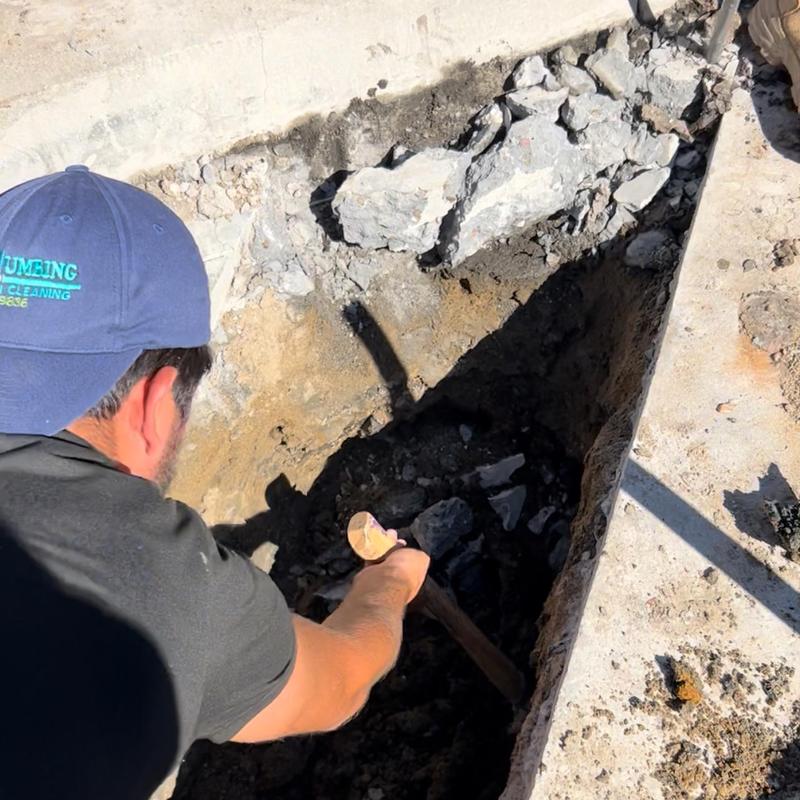 Collapsed drain pipe excavation and removal in concrete trench