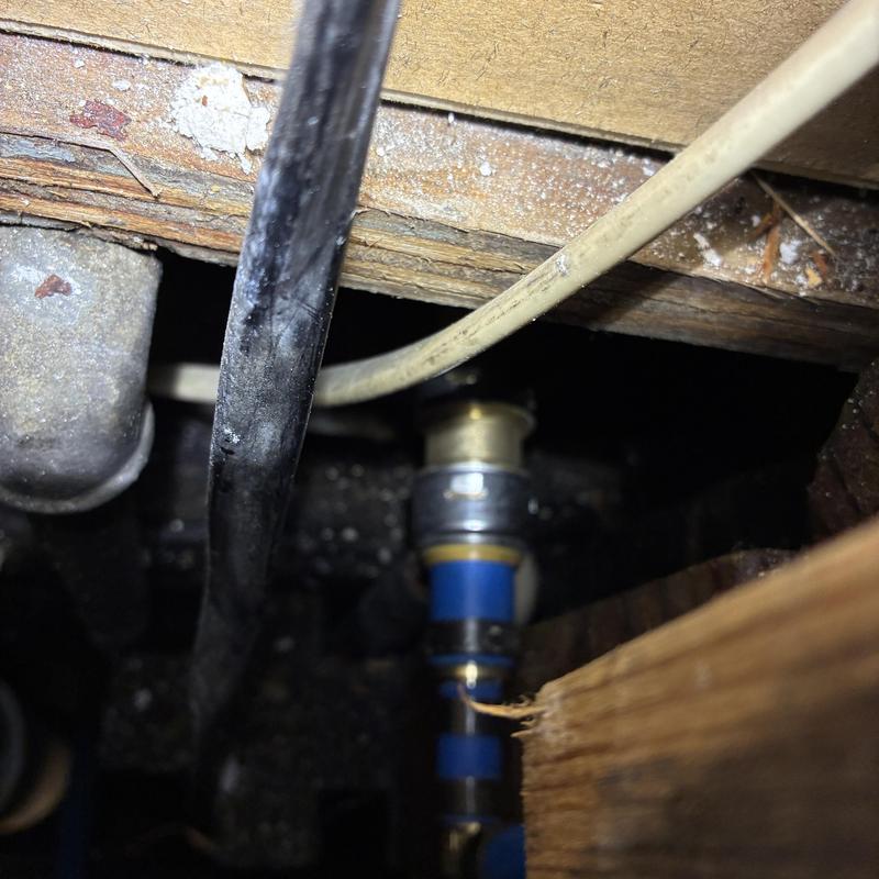 Toilet supply line with leak repair behind wall in crawl space