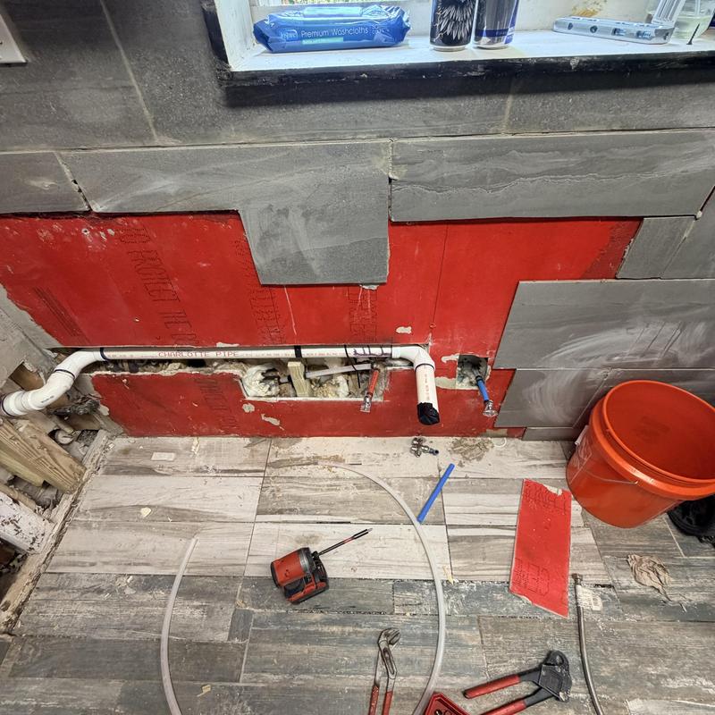 PVC drain line rerouted under kitchen sink cabinet