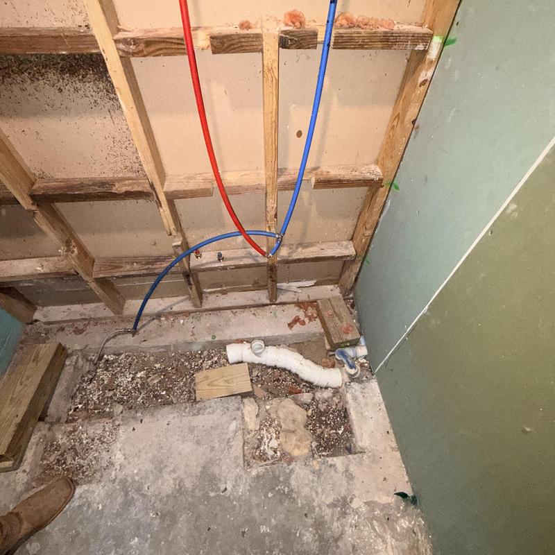 PVC drain line and water pipes rerouted under wall studs