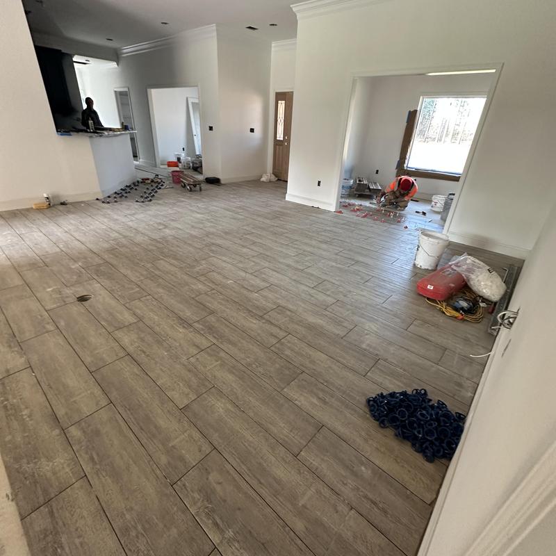 Tile plank flooring installation in living room Tile plank flooring installation in living room