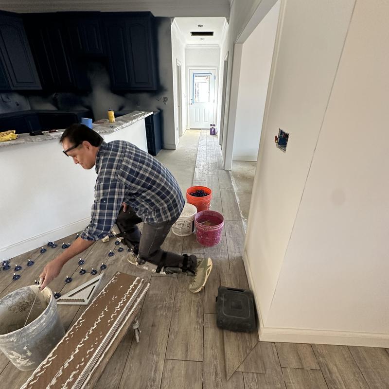 Tile plank flooring installation with spacers and adhesive Tile plank flooring installation with spacers and adhesive