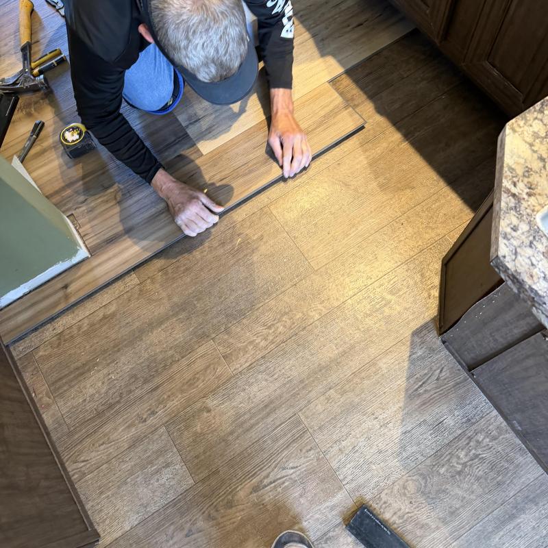 Vinyl plank flooring installation in kitchen area Vinyl plank flooring installation in kitchen area