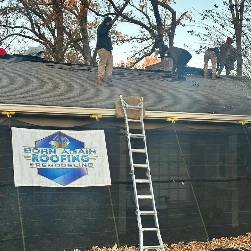 Asphalt shingle roof installation with crew and ladder Asphalt shingle roof installation with crew and ladder