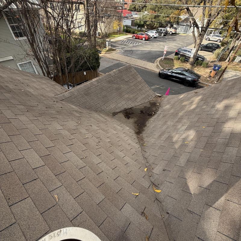 3-Tab shingle roof valley with water dam and debris