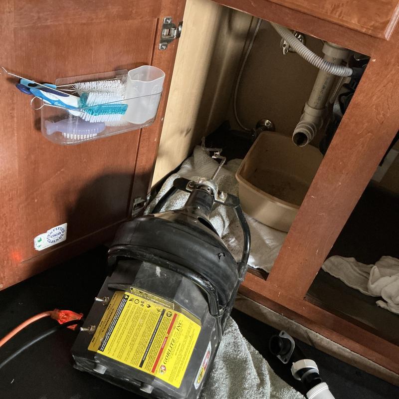 Kitchen drain clog cable machine inside cabinet