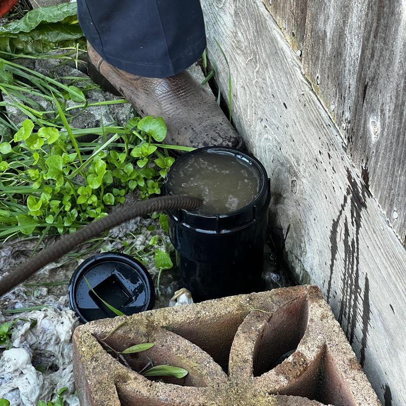 Main drain cleanout with snake removing clog