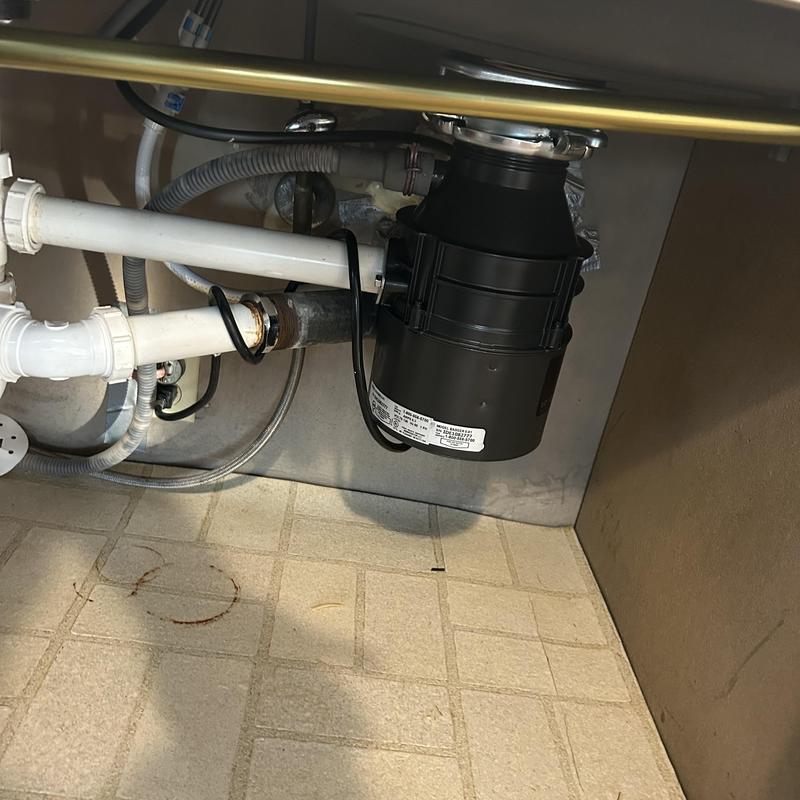 Garbage disposal unit under sink with drainage pipes