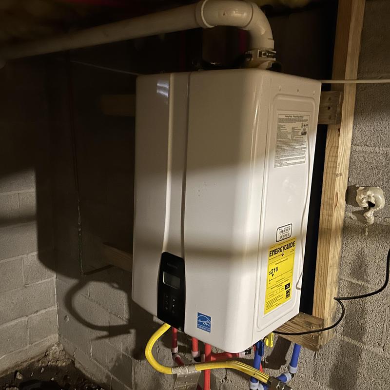 Tankless water heater installation with piping connections