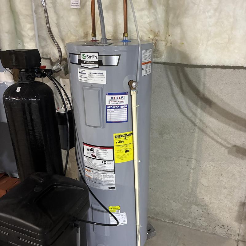 Tank water heater with maintenance setup in basement