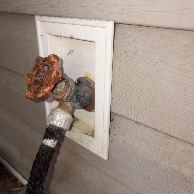 Outdoor hose bib with rusted valve handle