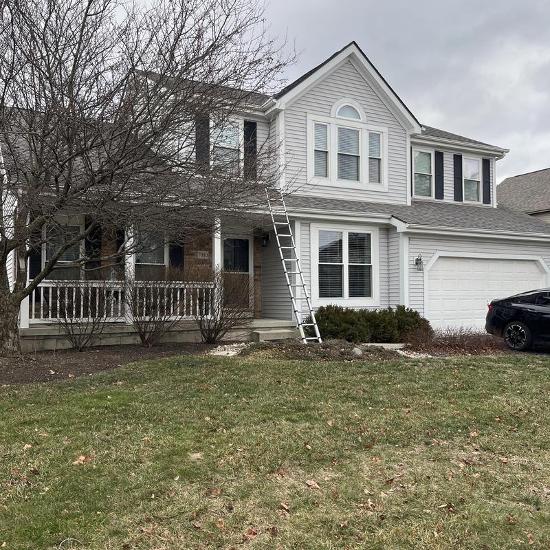 Roof shingles inspection with ladder on suburban house Roof shingles inspection with ladder on suburban house