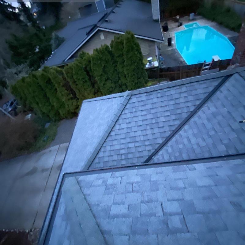 Asphalt shingle roof with cleaned gutters and debris removed