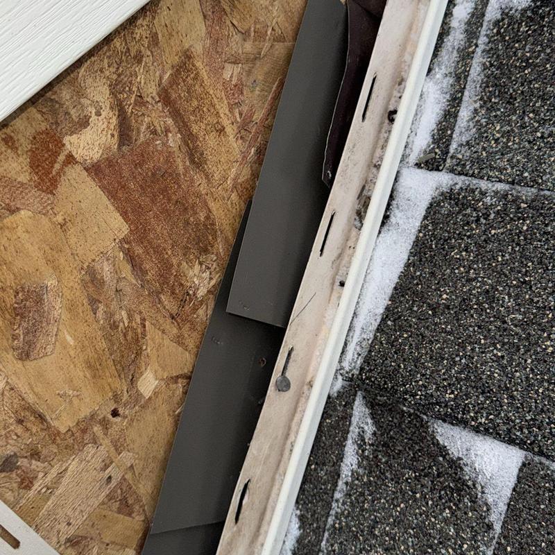 Window flashing installation beside shingled roof and siding panels