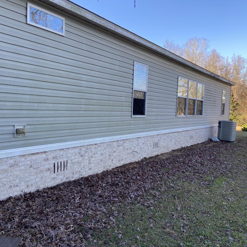 Brick skirting installed under mobile home exterior Brick skirting installed under mobile home exterior