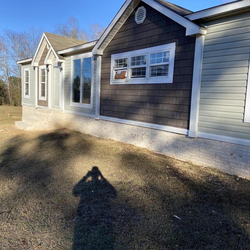 Brick skirting installed under mobile home exterior Brick skirting installed under mobile home exterior