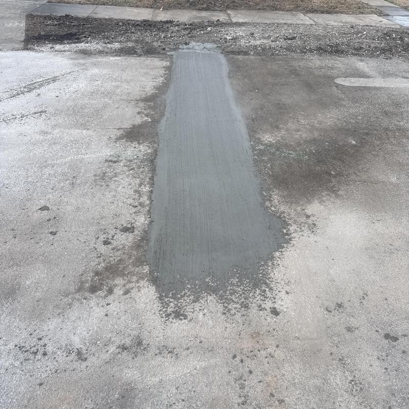 Sewer line concrete patch on road section Sewer line concrete patch on road section