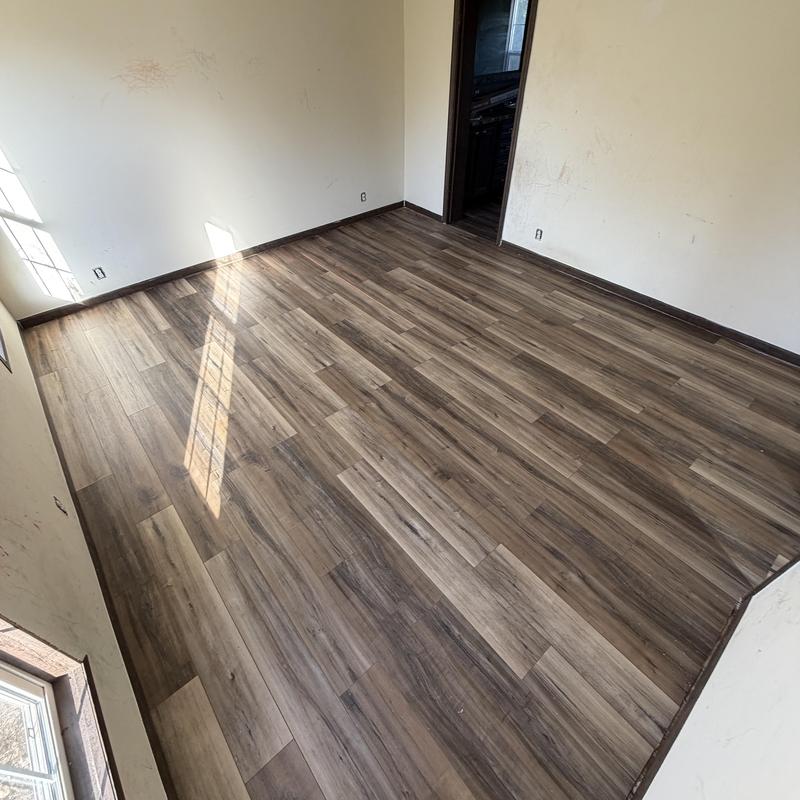 Vinyl plank floor installation in empty room Vinyl plank floor installation in empty room
