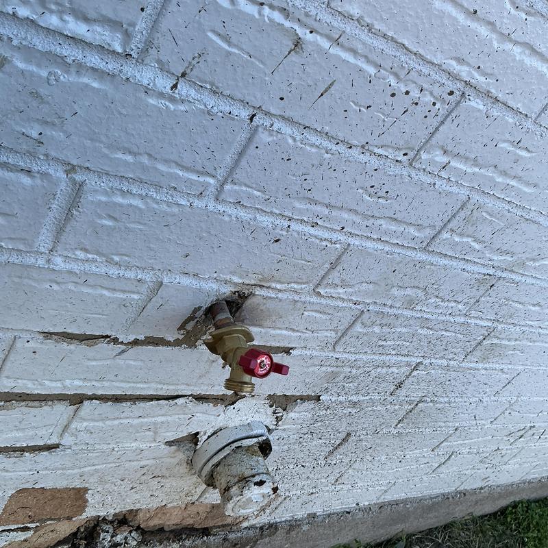 Backyard hose bib replacement on exterior brick wall