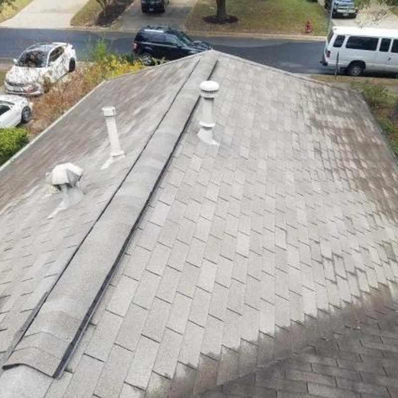 Asphalt shingle roof with ridge vents and plumbing vents