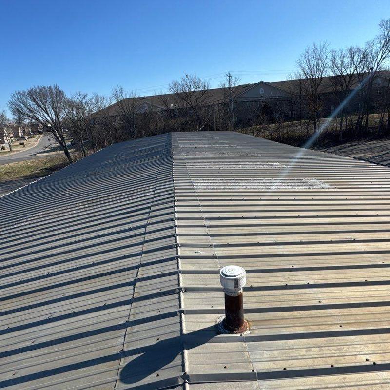 Metal church roof with hail damage and vent pipe