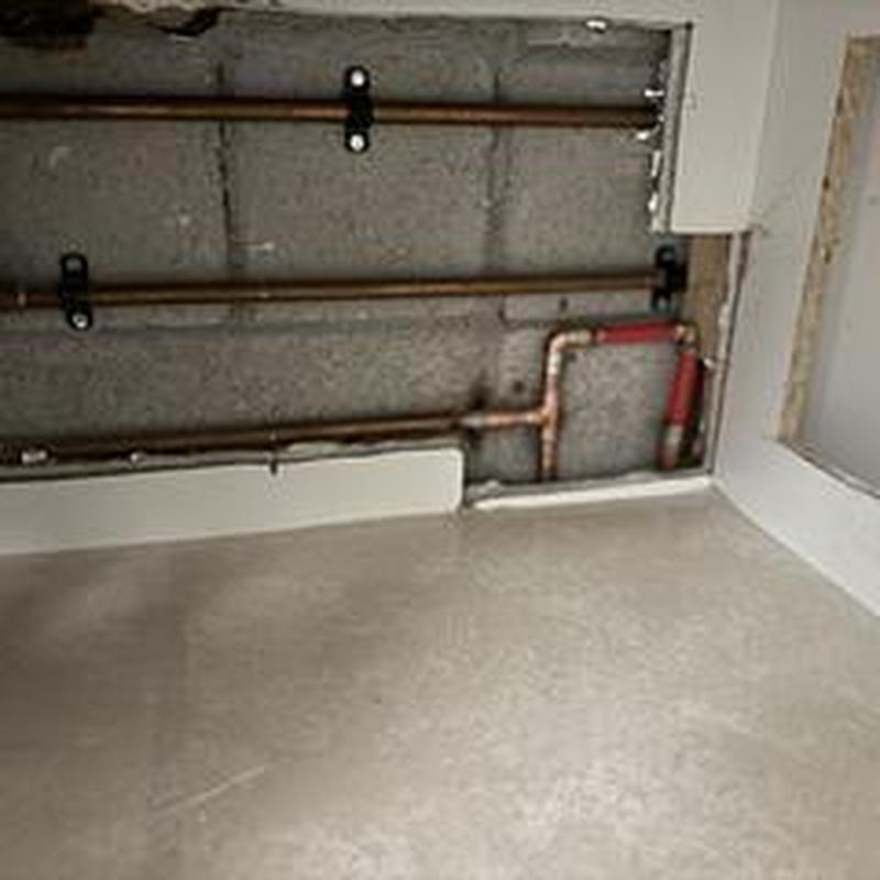 Copper hot water piping rerouted after slab leak fix