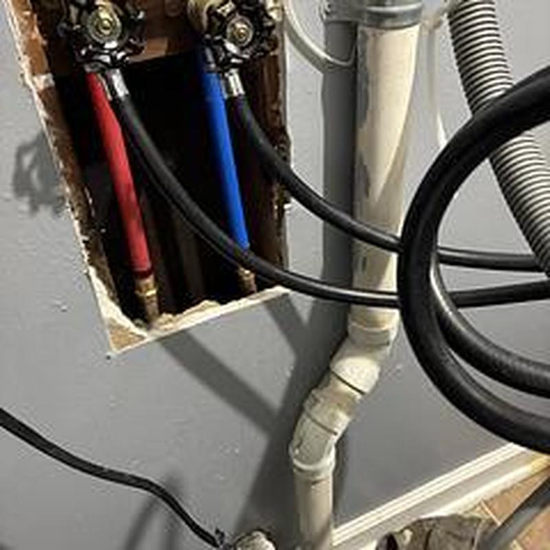 Laundry drain pipe with water supply lines and hoses