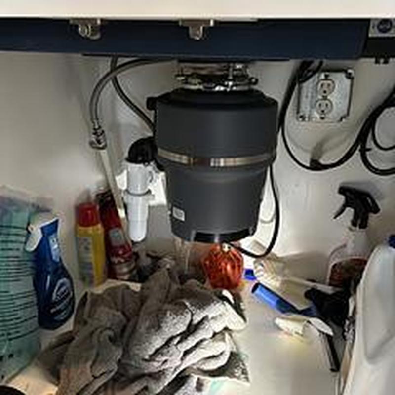 Garbage disposal installed under kitchen sink cleaning