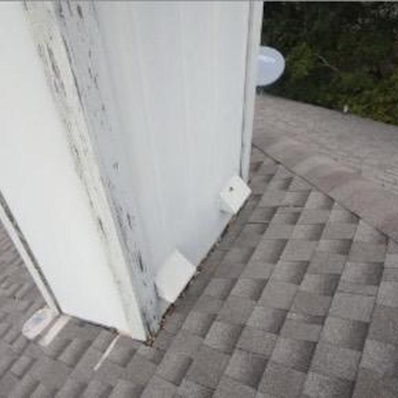 Chimney flashing and roof shingles with damage