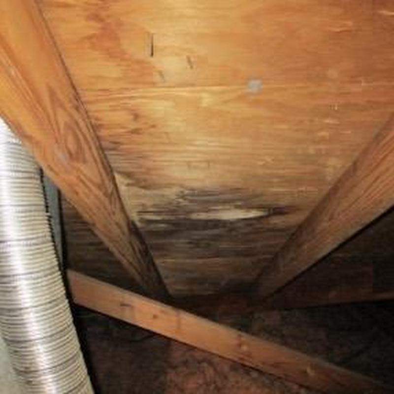 Roof deck water damage under chimney flashing