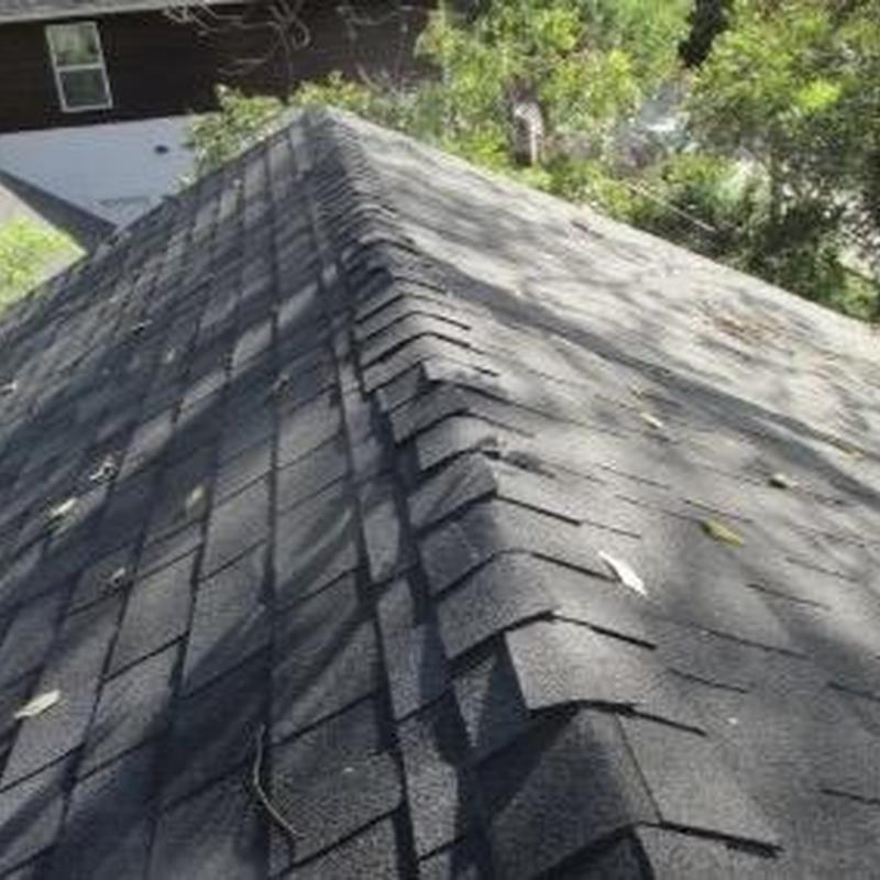 Asphalt shingle roof ridge with incorrect shingles