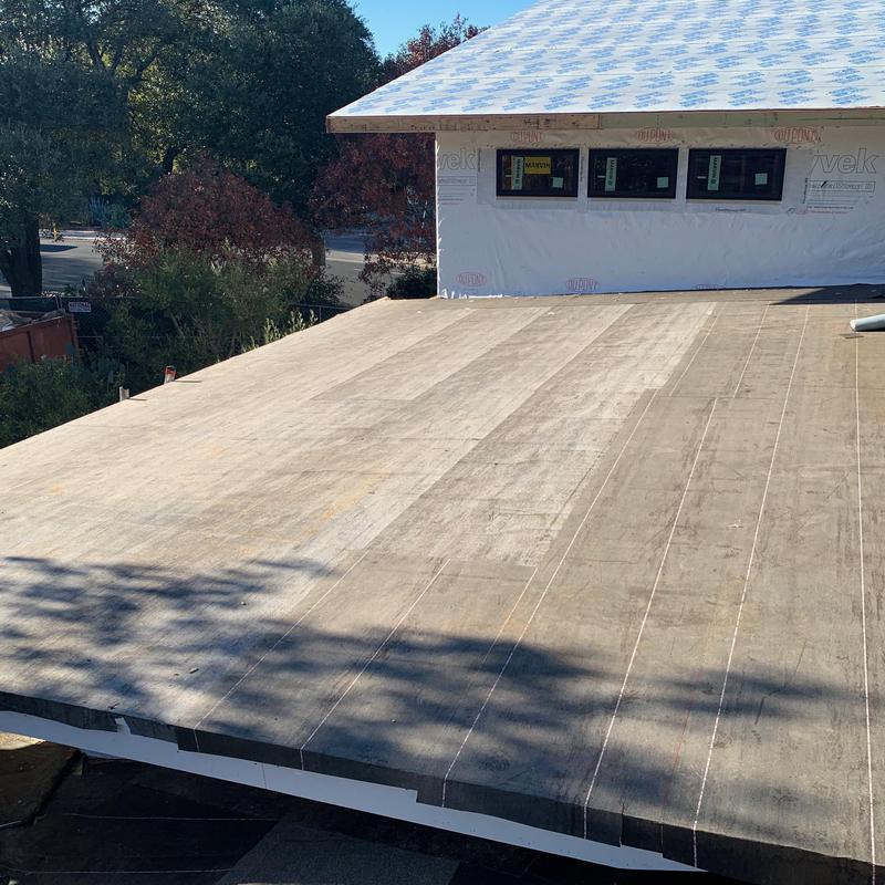 Plywood roof decking installed on house roof framing
