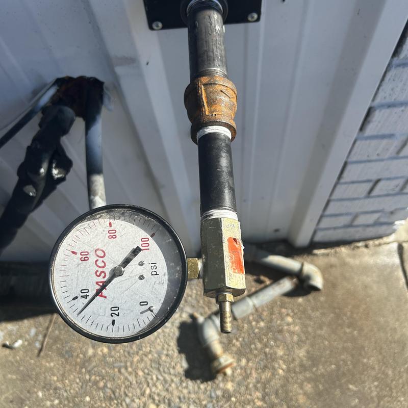 Gas pressure gauge on outdoor piping system