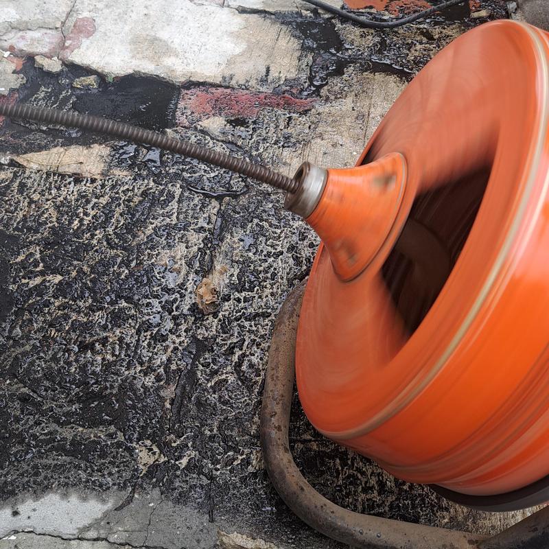 Exterior clean out cable machine clearing drain Exterior clean out cable machine clearing drain