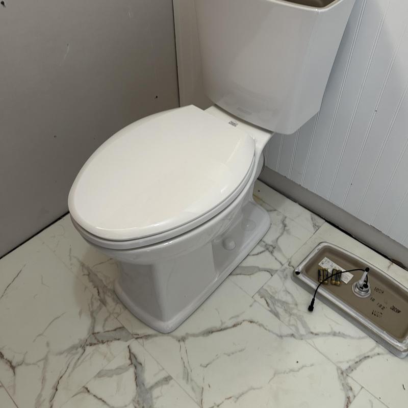 Toilet installation in bathroom with marble floor
