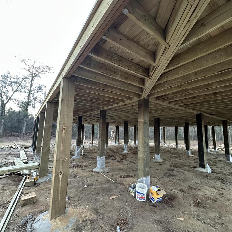 Foundation piers elevated 10 feet on wooden posts Foundation piers elevated 10 feet on wooden posts