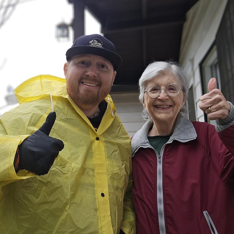 Sewer line root removal with happy customer thumbs up