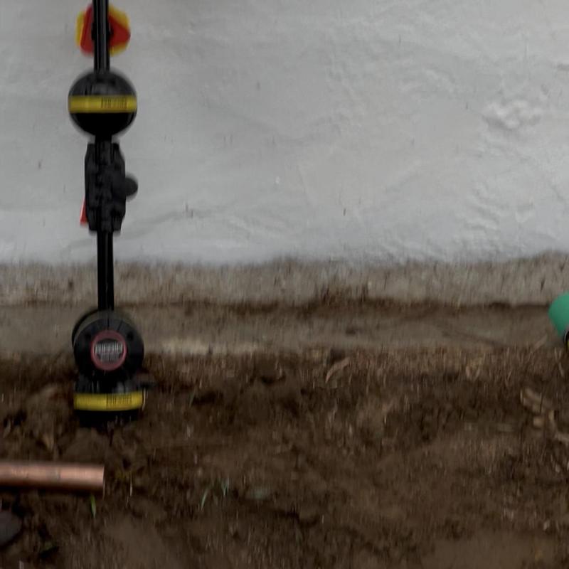 Gas meter installation at house foundation wall