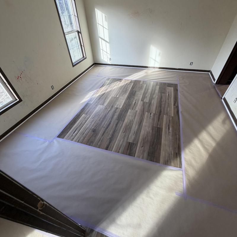 Vinyl plank floor section with protective paper covering Vinyl plank floor section with protective paper covering