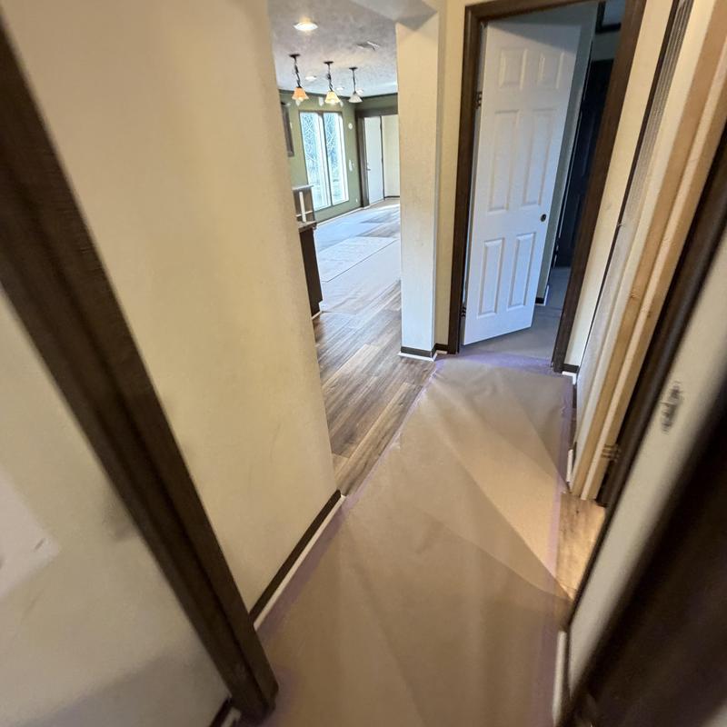 Vinyl plank flooring with protective paper and open door Vinyl plank flooring with protective paper and open door