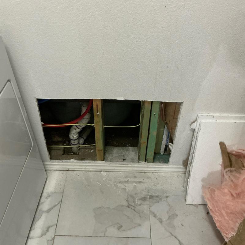 Water pipes inside wall cavity with insulation nearby