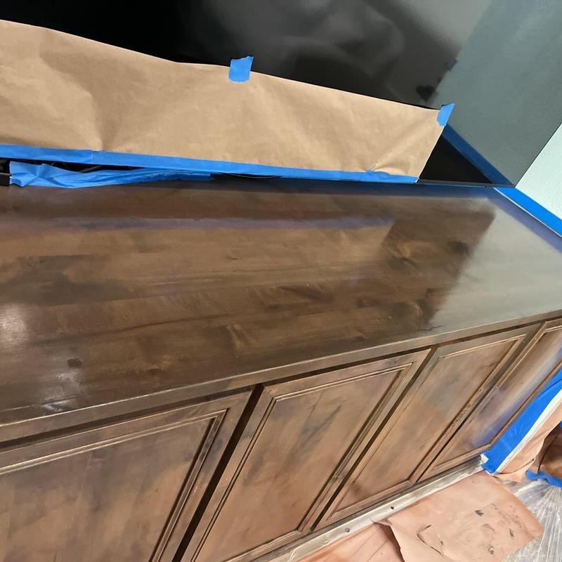 Wood cabinet stain application with protective masking