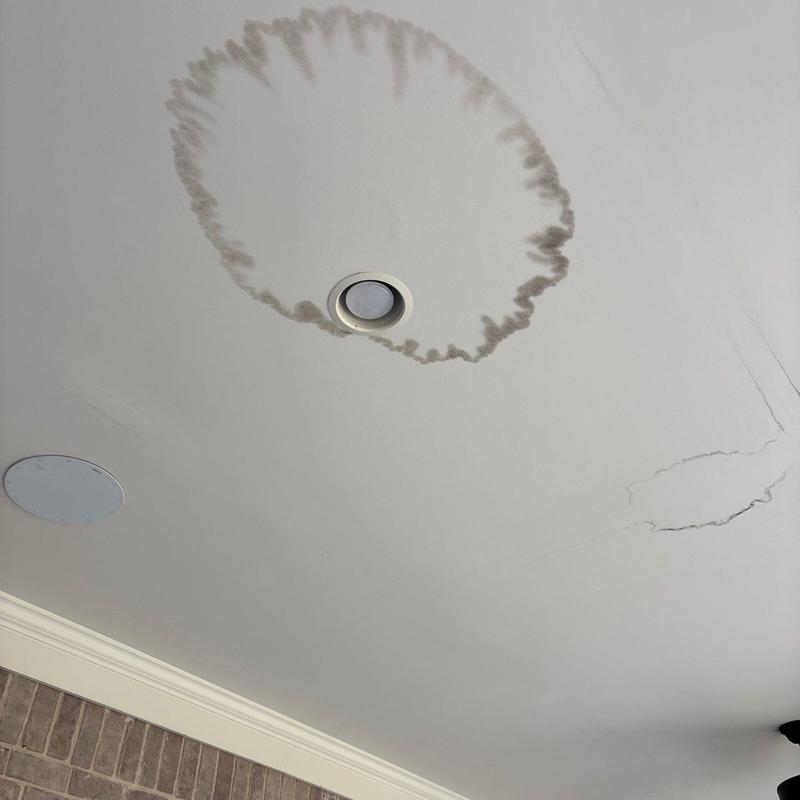 Ceiling drywall with water stain and cracks